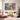 Large tribal nature landscape canvas wall art featuring colorful ocean waves, volcanoes and shells displayed in a bohemian living room setup.