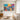 Wide format hand painted folk art nature canvas artwork displaying intricate hand drawn details along a bright entryway gallery hallway wall.