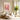Textured confetti-style floral painting as a bold focal point above a wooden console and ceramic vases in an airy contemporary living room