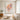 Textured loose floral painting as a focal point above a walnut media console with ceramic vases in a cozy contemporary living room