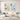 Hand painted beige and ice blue abstract canvas painting set of 2 with thick knife texture hanging over a modern cream sofa in a living room.