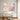 Soft rose pink abstract flower canvas art set of 2 creating a warm romantic dining experience mounted above an oval wooden dining room table.