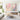 Framed 3D impasto pink blossom oil painting set showing sculptural white palette knife strokes over a wooden sideboard in an elegant living room.
