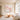 Large impressionist cherry blossom canvas wall art with floating pink and lavender petals displayed in a Japandi minimalist living room.