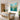 Refreshing green and pink abstract meadow canvas painting creating a light crisp atmosphere mounted above a modern dining room table.