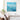 Large blue impasto ocean seascape canvas art hanging above armchair seats in a minimalist living room.