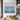Impasto seascape canvas art displayed in a modern living room next to high glass windows and gold coffee tables.