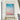 Oversized vertical aerial sea foam and pink sand canvas artwork mounted in a modern white hallway by a wooden staircase.